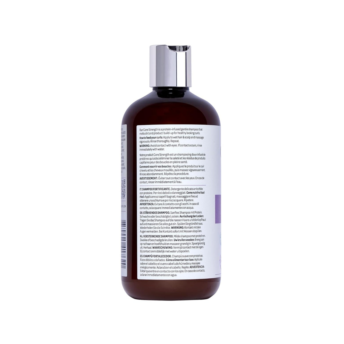 Brun plastflaske med sølvlåg af Core Strength shampoo med etiket i flersprogede brugsanvisninger.